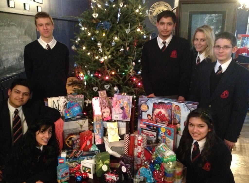 students posing with donated items received as part of the Christmas Families series of fundraisers organized by students from King's College School, a private school serving students in the Caledon, Brampton, Orangeville and Bolton areas